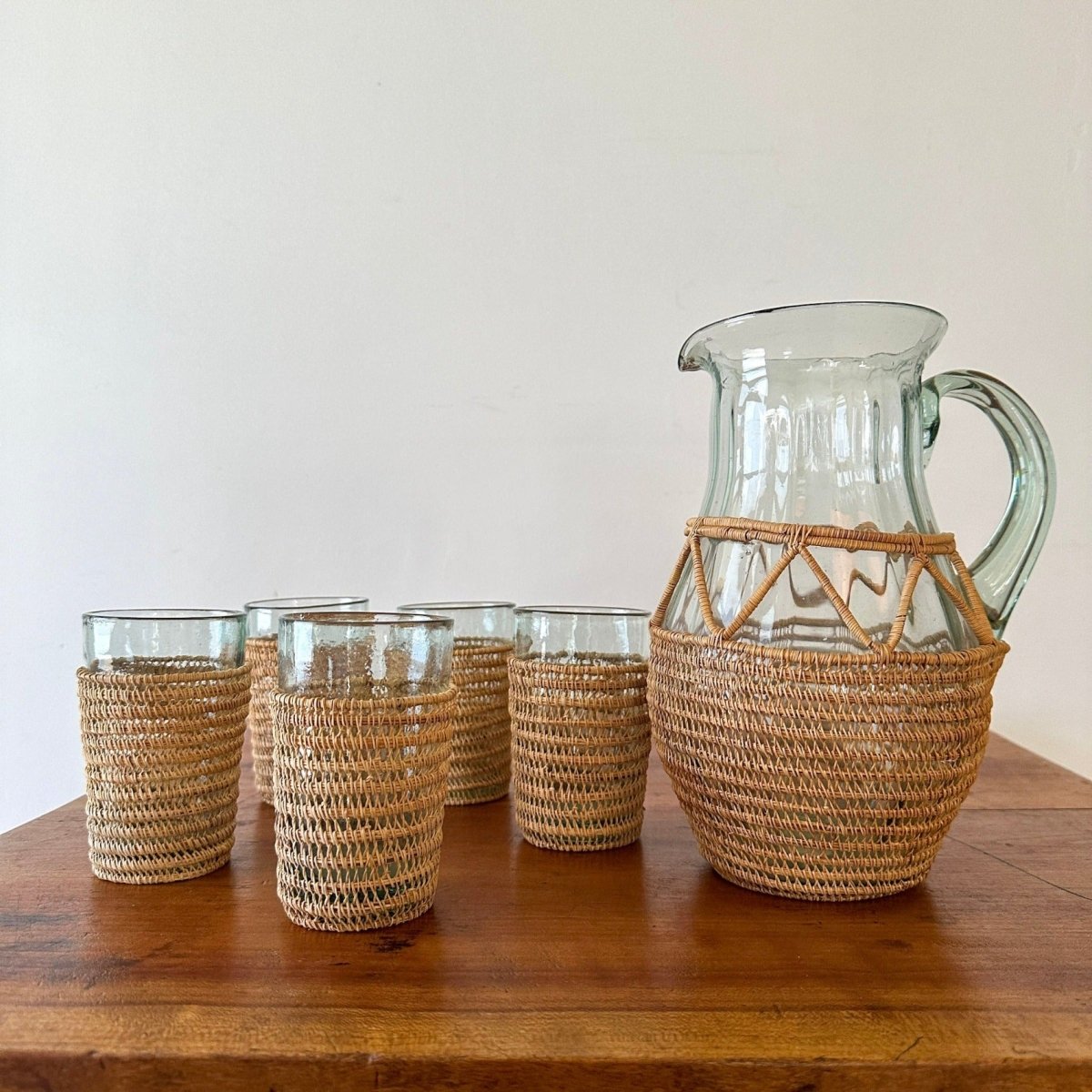 http://spacehavenhome.com/cdn/shop/products/wicker-and-glass-juice-pitcher-and-glass-set-757256.jpg?v=1679194565
